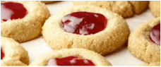 Close-up of thumbprint cookies filled with red jam.
