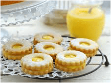 Lemon cookies with a glaze on a cooling rack.