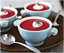 Creamy beet soup served in white cups with a dollop of cream and dill garnish.