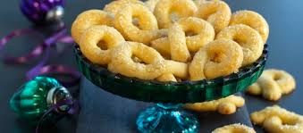 Golden fried snacks served on a blue glass pedestal dish.