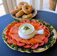 Smoked salmon platter with cream cheese and bagels on the side.