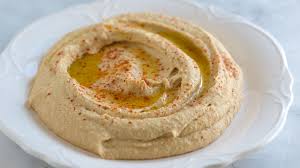 Creamy hummus drizzled with olive oil and sprinkled with paprika.