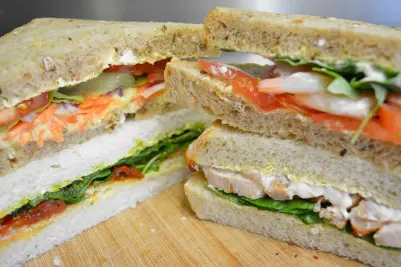 Close-up of fresh sandwiches with lettuce, tomato, and chicken.