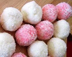 Pink and white coconut-covered sweet balls arranged together.