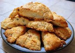 Freshly baked scones with a golden crust on a plate.