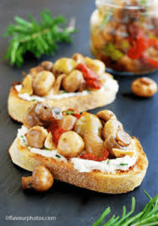 Two slices of bread topped with mushrooms and herbs.