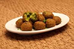 Plate of crispy falafel balls on a white dish.