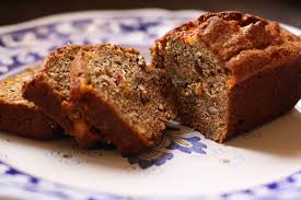 Sliced nut bread on a floral plate.