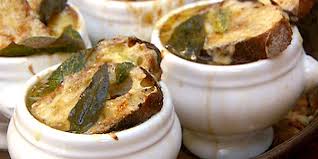 Close-up of baked savory soufflés in white ramekins.