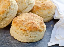 Freshly baked golden biscuits with a flaky texture.