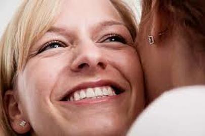 Close-up of a smiling woman with a joyful expression.