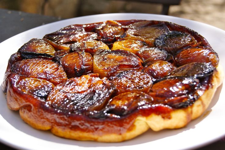 A caramelized plum tart with a golden crust.