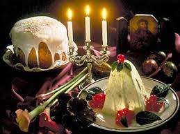 Festive holiday dessert table with candles and cake.