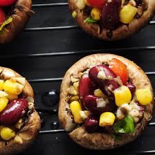 Stuffed mushrooms topped with colorful beans and corn.