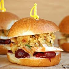 A sandwich with crispy fried filling and sauce in a soft bun.