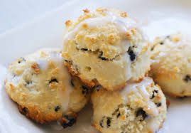 Close-up of three coconut macaroons with a golden crust and raisins.