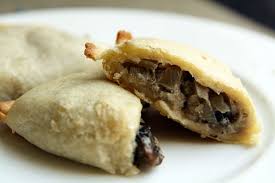 Close-up of a stuffed pastry with mushroom filling.