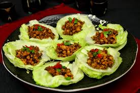 Lettuce wraps filled with seasoned ground meat and vegetables.