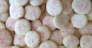 Close-up of round cookies with pink sprinkles.