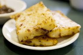 Close-up of three pieces of savory flatbread on a white plate.