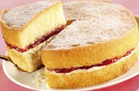 A classic sponge cake with jam and cream filling, dusted with powdered sugar.