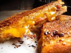 Golden grilled cheese sandwich with melted cheddar cheese.
