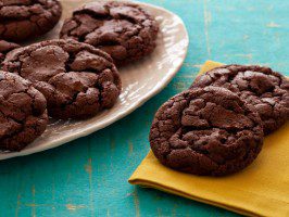 Delicious chocolate cookies on a turquoise surface with a yellow napkin.