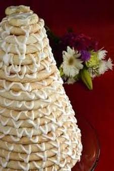 Decorative cream-covered cake with floral garnish.