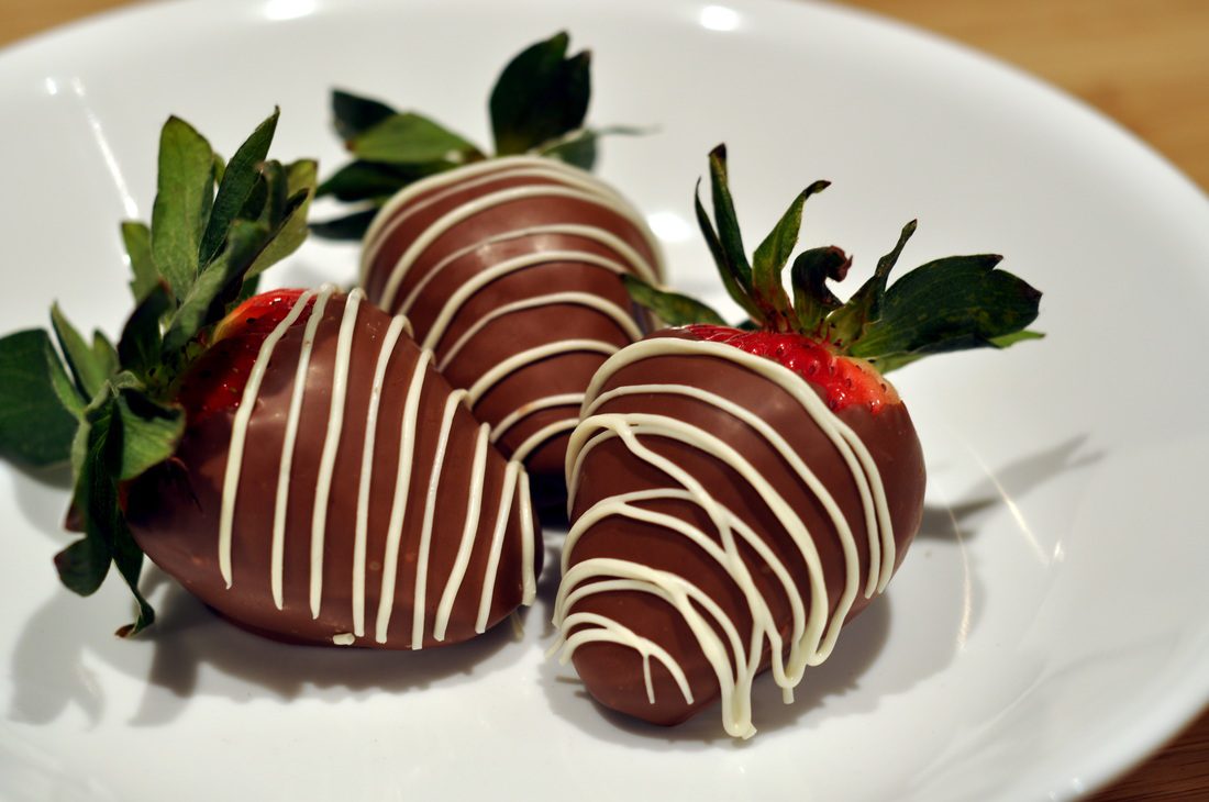 Fresh strawberries dipped in chocolate with white chocolate drizzle.
