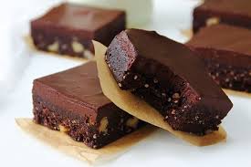 Close-up of chocolate fudge brownies on parchment paper.