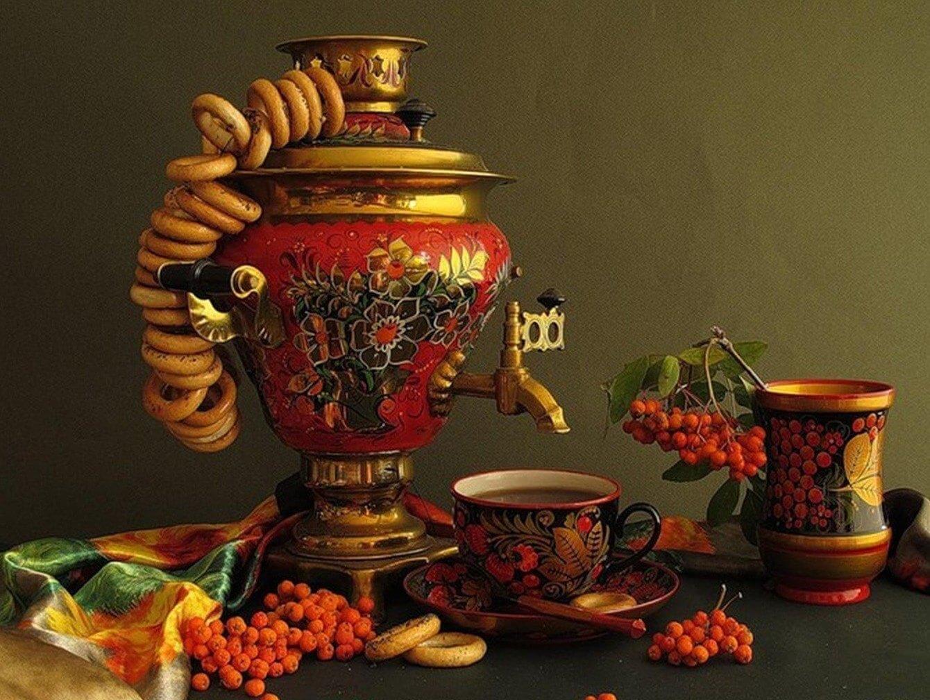 A traditional Russian samovar with tea set and bagels.