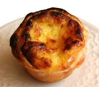 A close-up of a golden-brown pastel de nata tart.