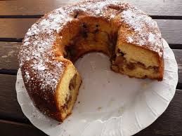 A sliced cinnamon swirl bundt cake dusted with powdered sugar.