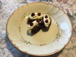 Three stuffed dates on a decorative plate.