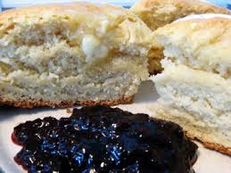 Biscuits with butter and dark berry jam on the side.