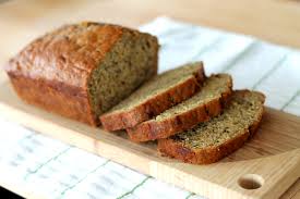 Sliced homemade banana bread on a wooden board.