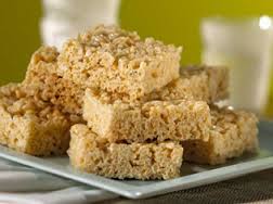 Stack of homemade rice crispy treat squares on a plate.