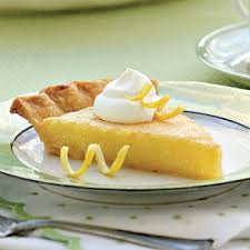 A slice of lemon meringue pie with whipped cream on top.