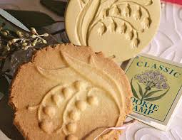 Decorative round cookies with floral impressions and packaging.