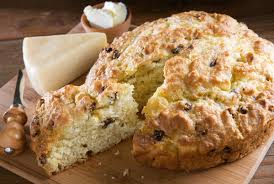 A freshly baked Irish soda bread with a slice cut out.
