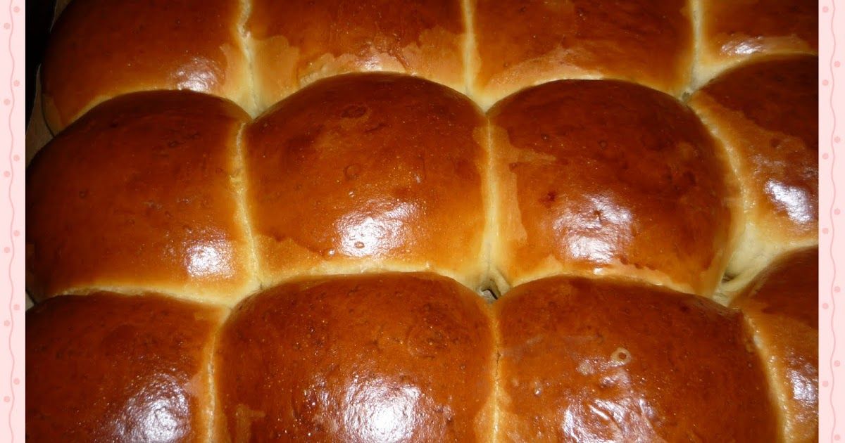 Golden brown bread rolls closely packed together.