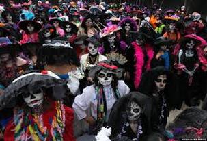 A crowd dressed as skeletons in colorful costumes during a festive event.