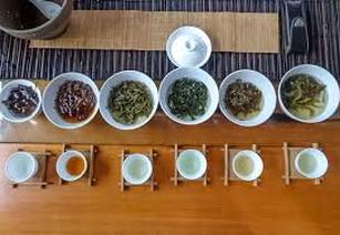 A tea tasting setup with various teas and condiments.