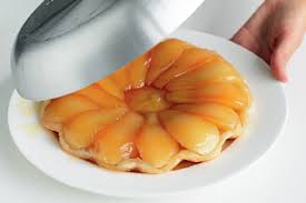 A pear tart with glossy pear slices on a pastry base.