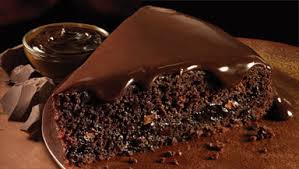 Close-up of a moist chocolate cake slice with rich chocolate frosting.