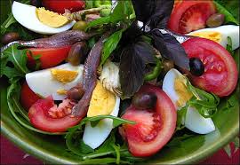 Fresh salad with tomatoes, eggs, and greens.
