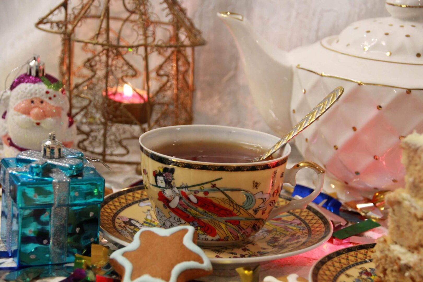 A decorative cup of tea with a star-shaped cookie on a vibrant tray.