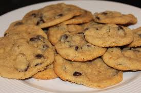 Freshly baked chocolate chip cookies on a plate.