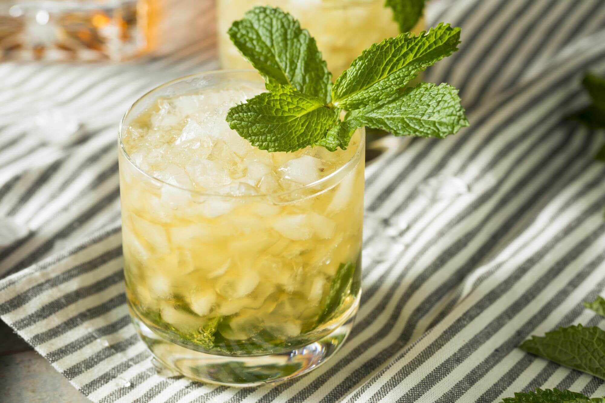 Refreshing mojito cocktail with mint garnish and crushed ice.