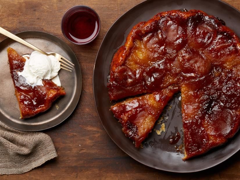 A sticky barbecue glazed pizza with a slice removed and a glass of red drink.